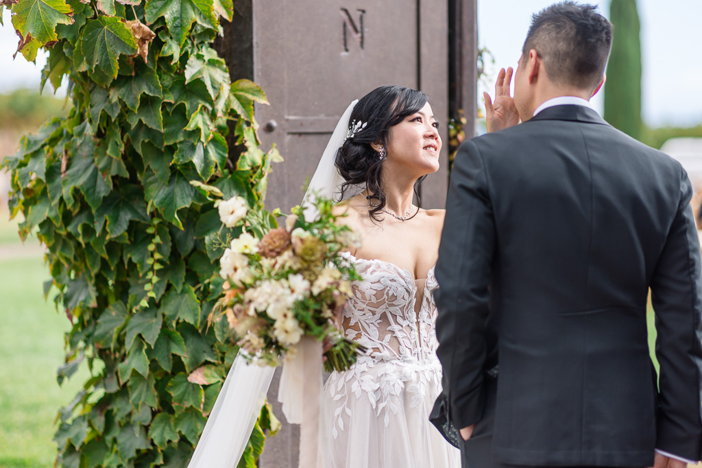 bride helping to wipe a tear from her groom's face