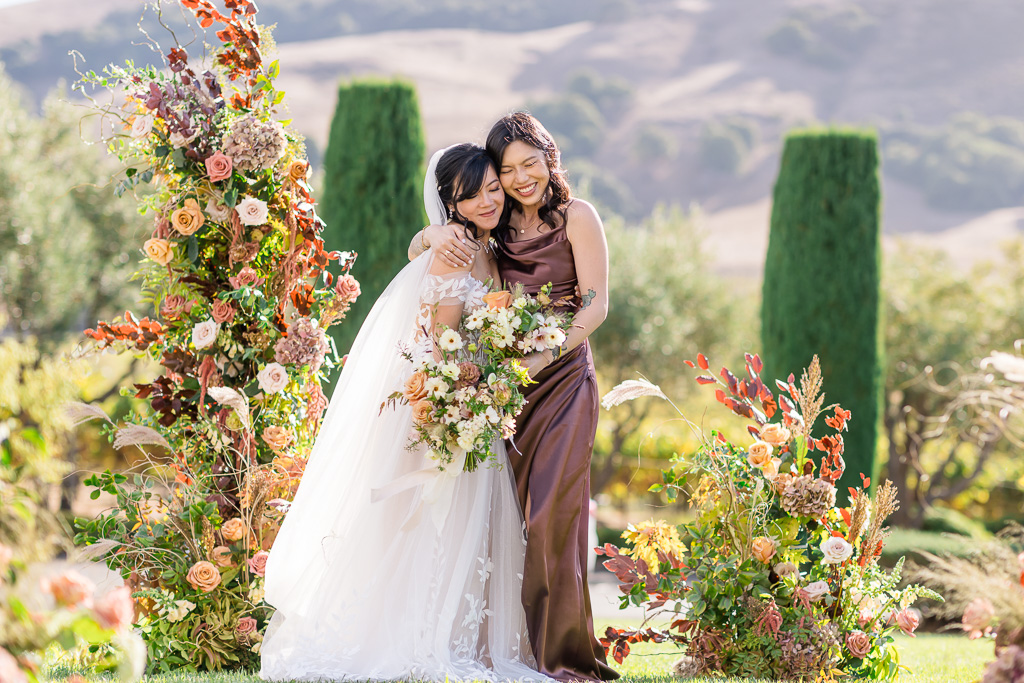 bride and her bridesmaid having a sweet moment together