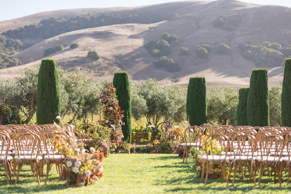 Viansa Sonoma ceremony setup and decor with wooden chairs and flowers