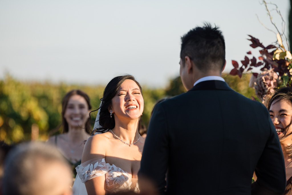 a happy bride laughing during the ceremony