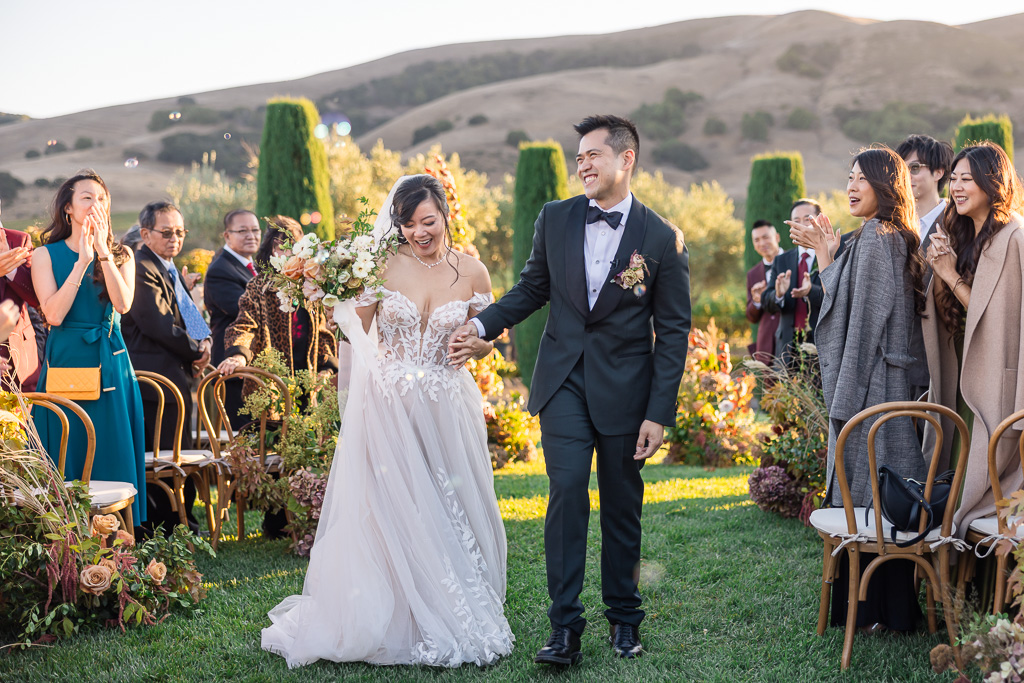 walking back up the aisle with bubbles being blown by guests