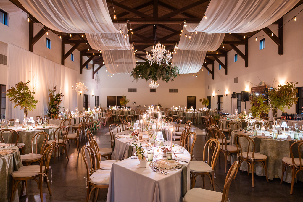 beautiful and elegant indoor reception decor at Viansa Sonoma with lush florals and wavy drapery