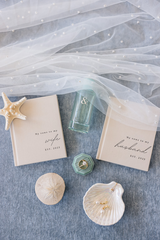wedding details and vow books flat lay