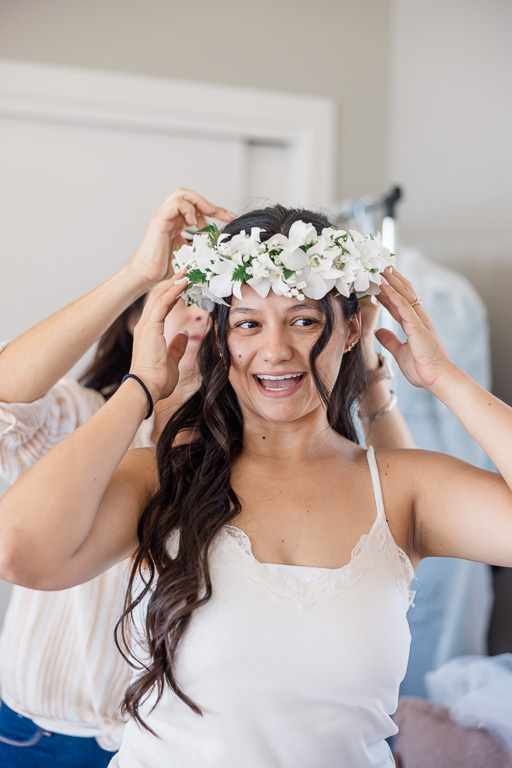 haku lei being placed on bride