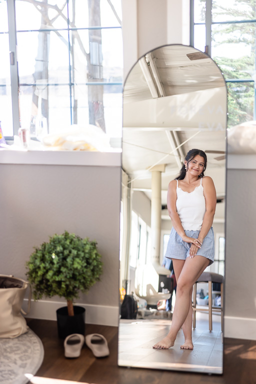 bride admiring herself in floor-length mirror