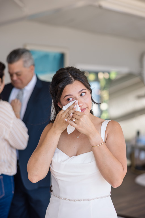 the bride wiping away a tear during an emotional moment