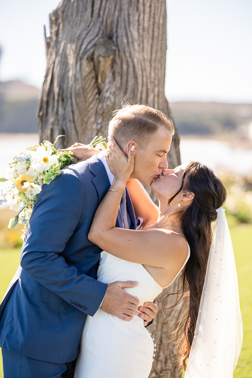 the bride and groom kissing