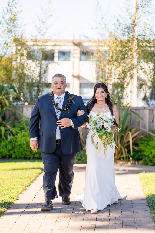 bride and dad entering the wedding ceremony area