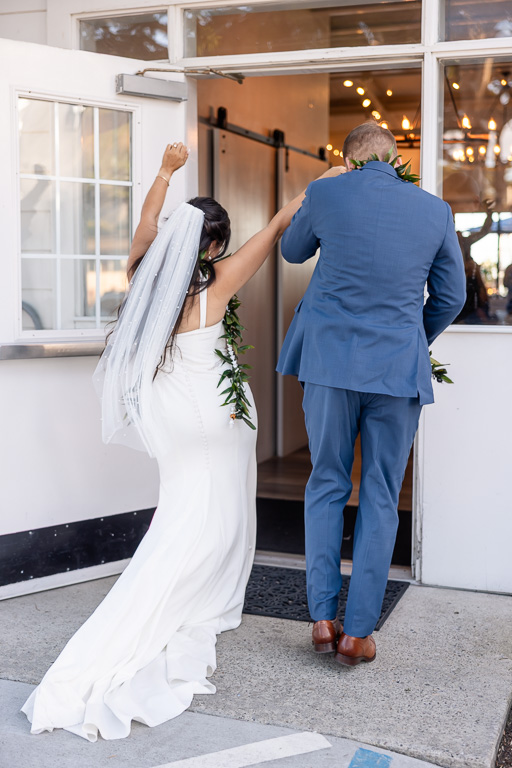 bride and groom entering the reception hall