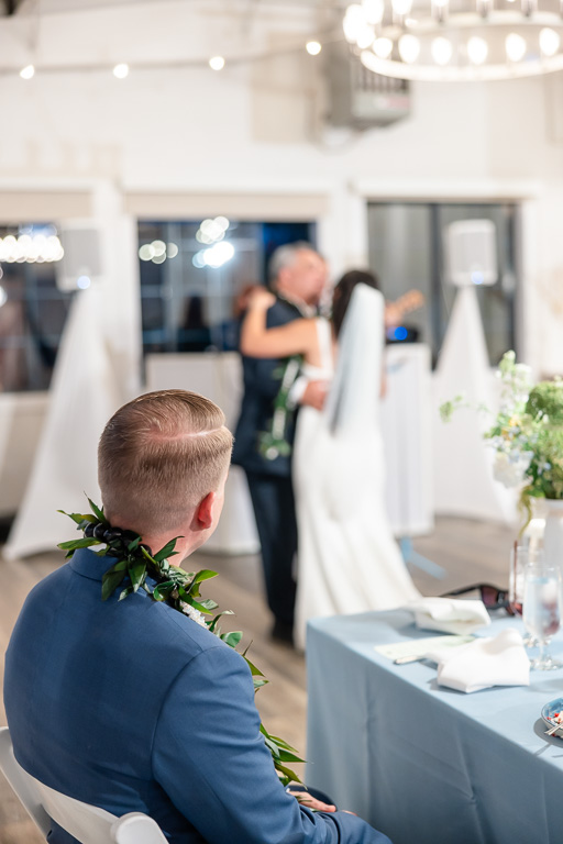 the groom watching the bride and her dad share a dance