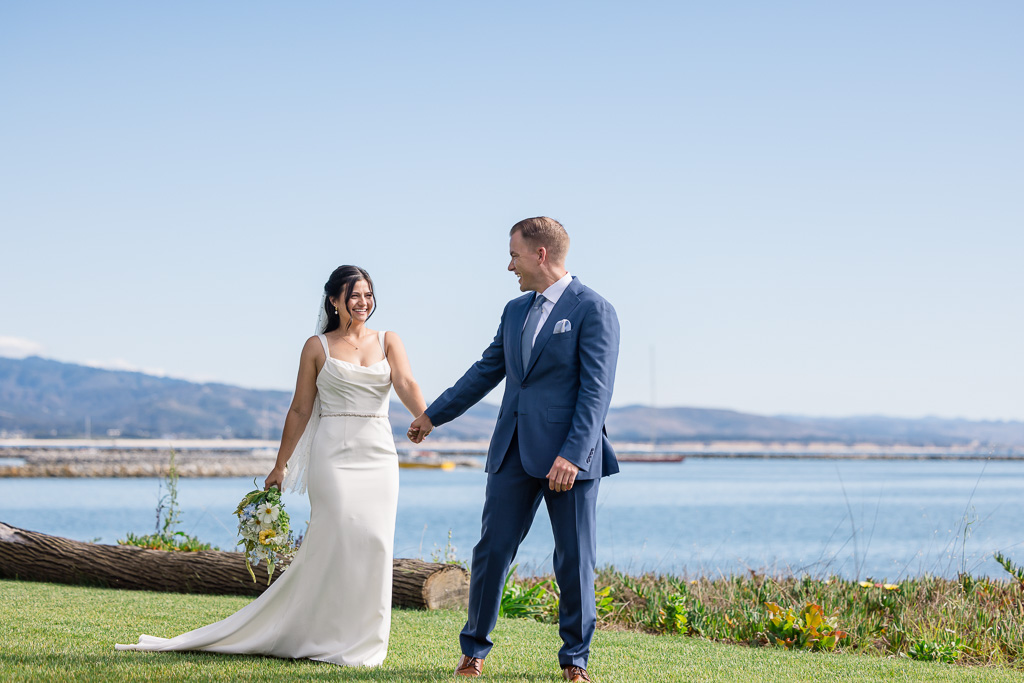 wedding portraits on a grassy lawn along the ocean
