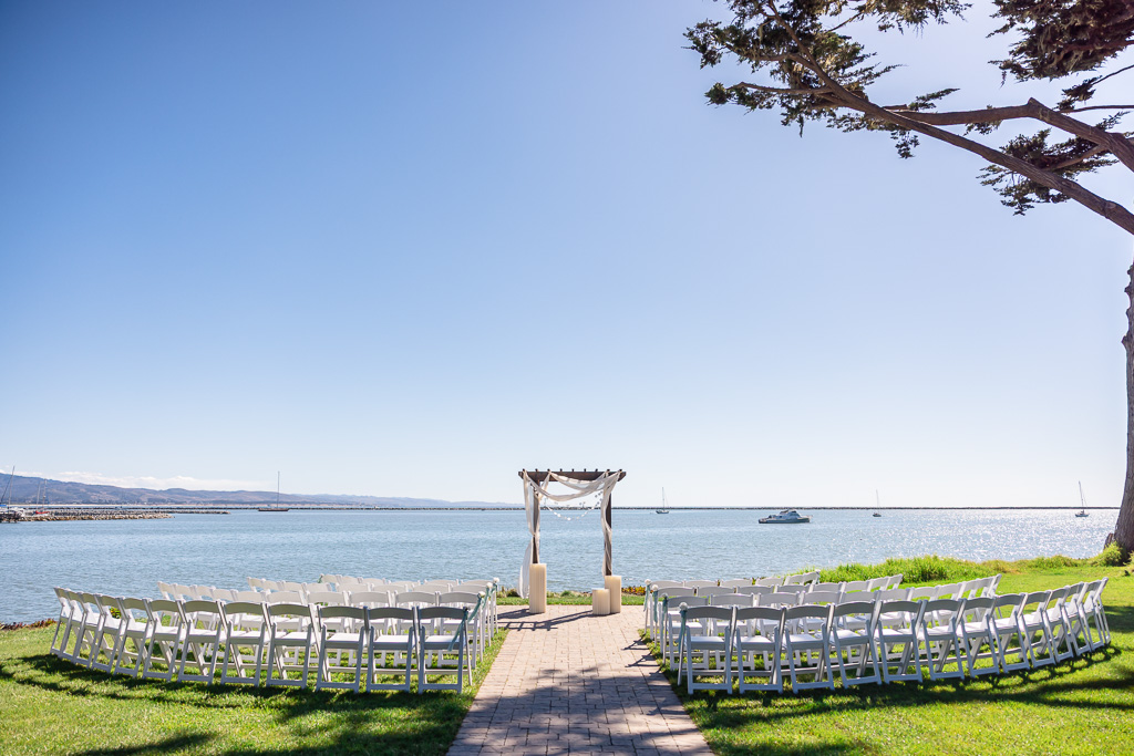 wedding ceremony setup with chairs and arbor at Mavericks House