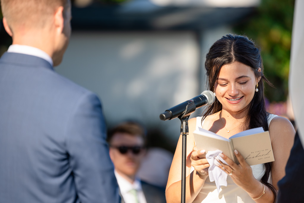 bride reading her vows out of a custom vow book