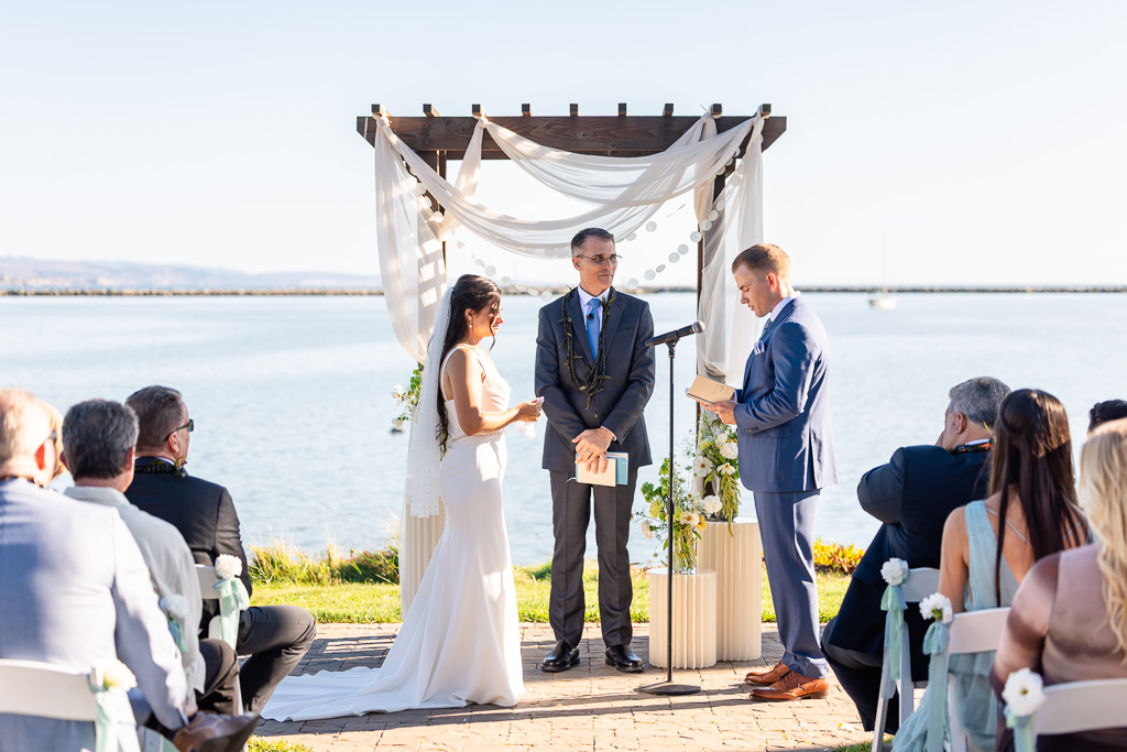 groom delivering personal vows to the bride during the vows exchange portion of the ceremony