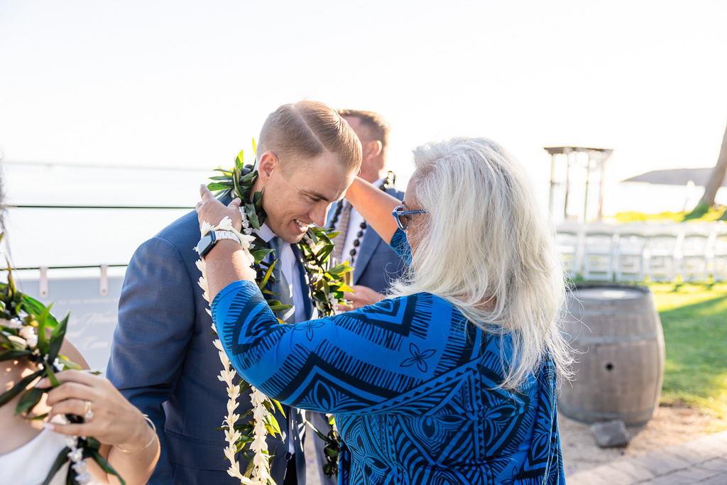 groom receiving lei during Hawaiian lei ceremony