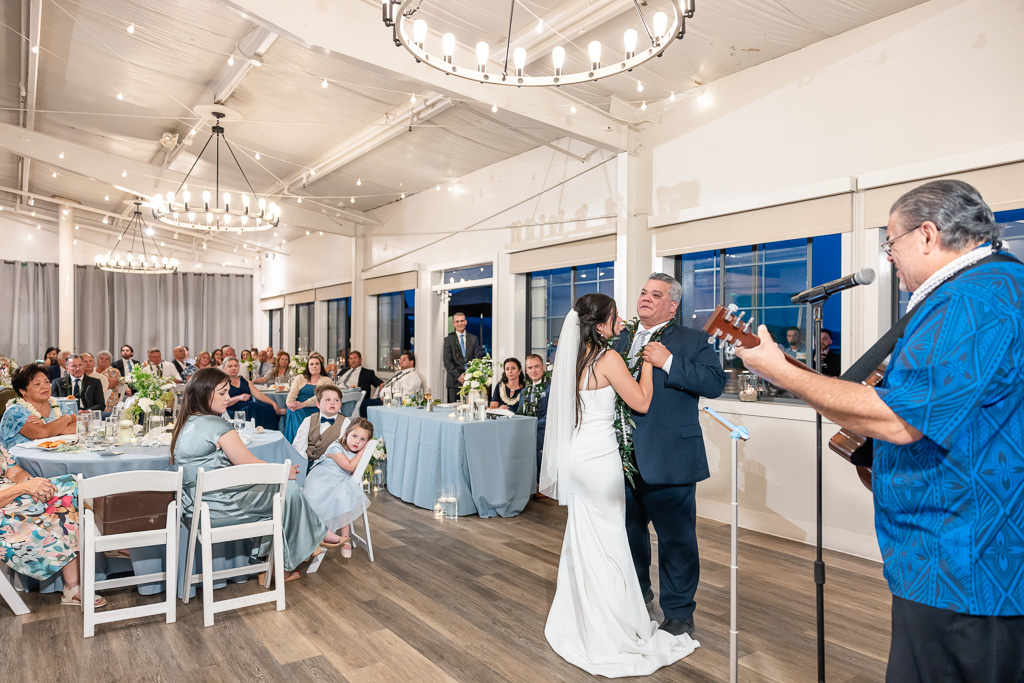bride and dad dancing while uncle sings and plays banjo