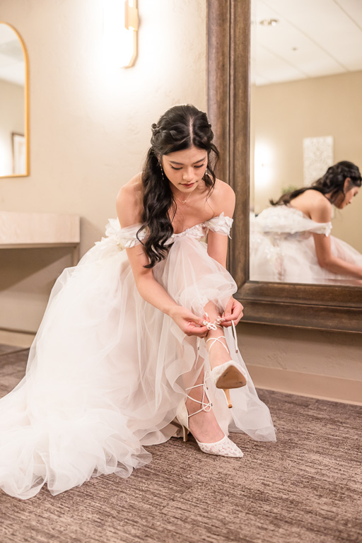 lacing up bride's shoes
