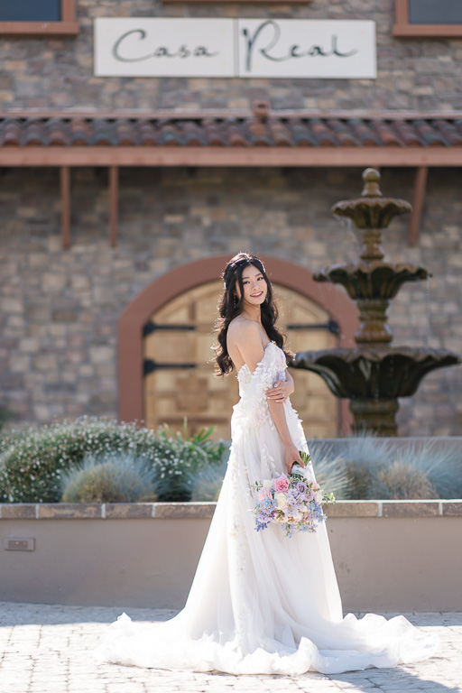 bride outside by a fountain