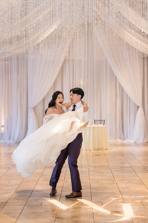 bride and groom practicing their first dance spin