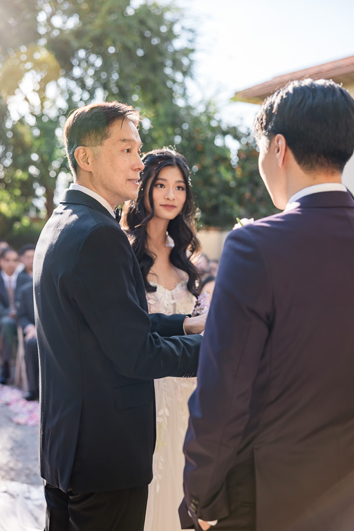 bride's dad handing her off at the end of the aisle