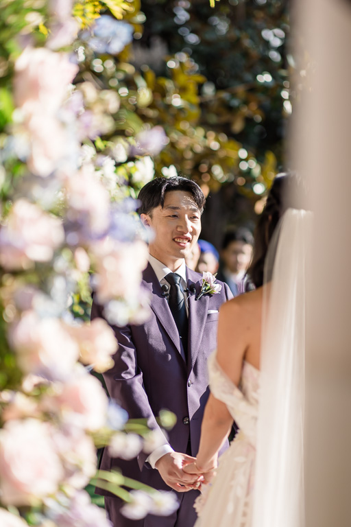 sneaky photo of the groom during wedding ceremony