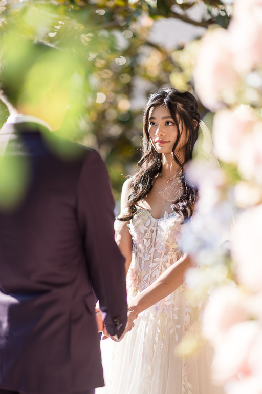 paparazzi-style photo of bride during outdoor wedding ceremony