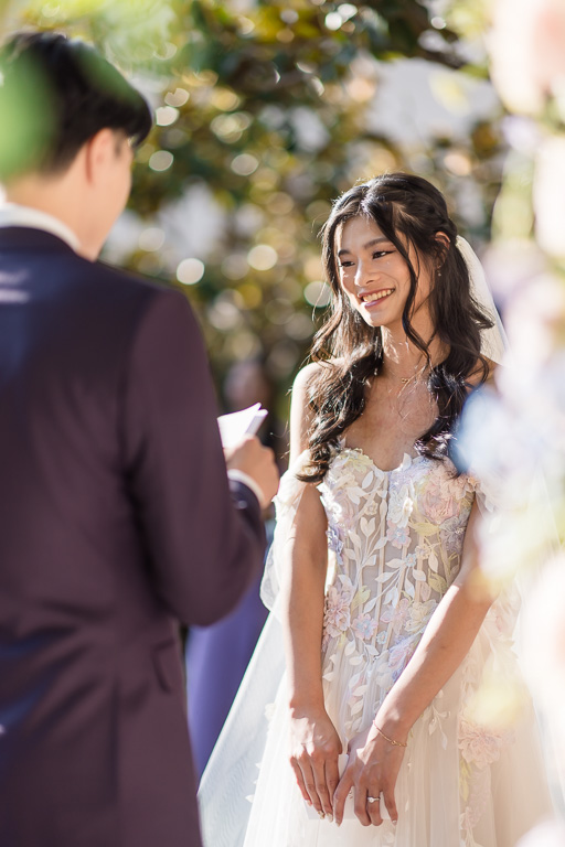 bride listening to groom's vows