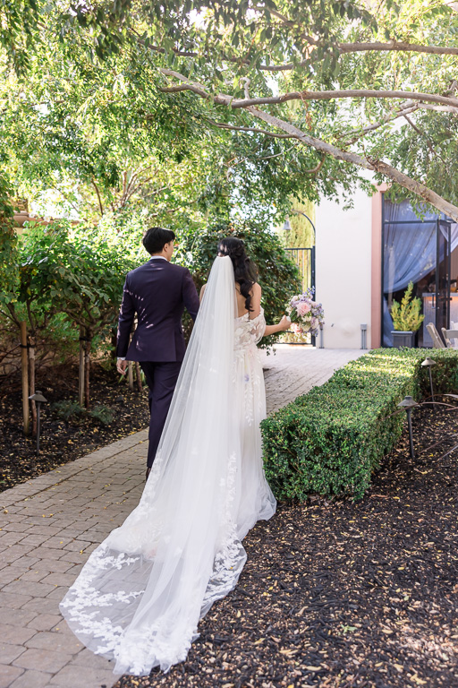 bride and groom walking away from the ceremony to go celebrate