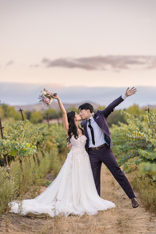 silly wedding photo in vineyards