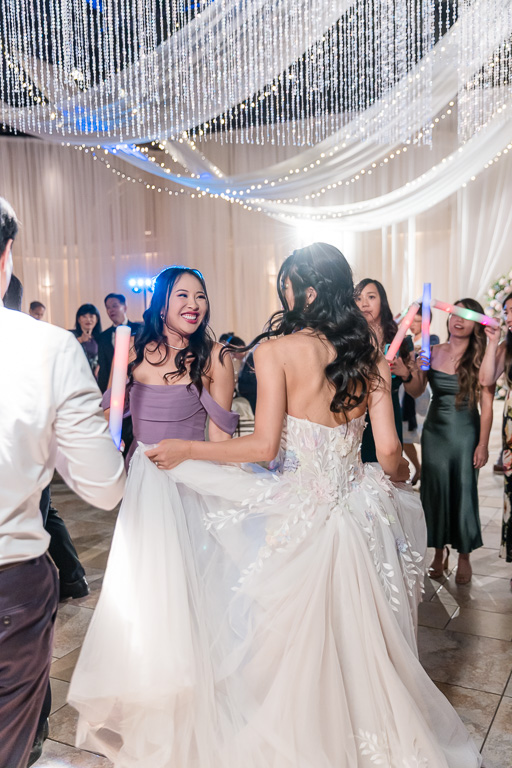 bride enjoying dancing with her bridesmaids