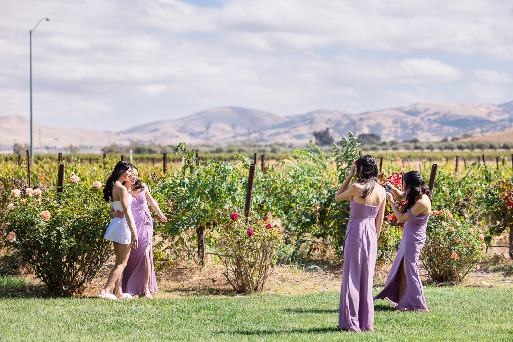 candid photo of bridesmaids and bride taking some selfies