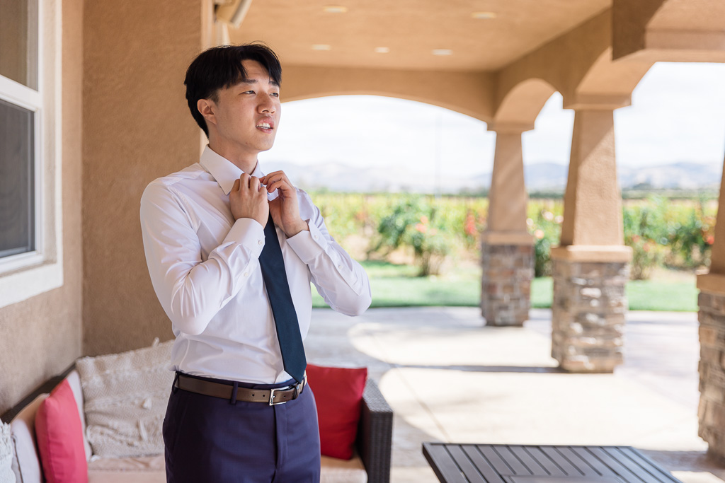 groom fixing up his tie