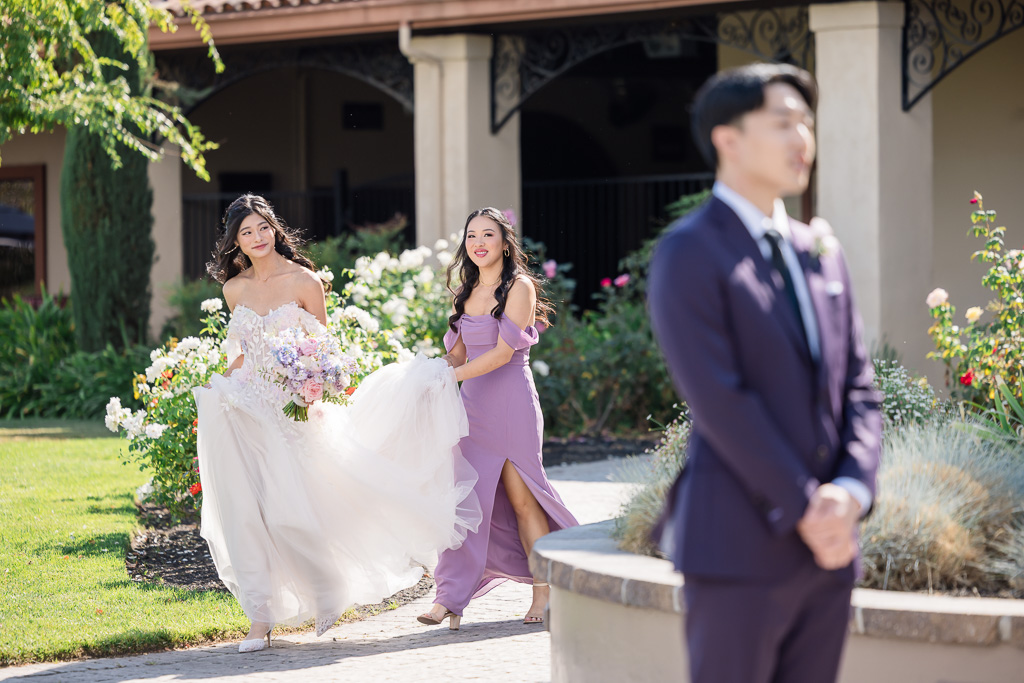 Bride walking with bridesmaid for her first look