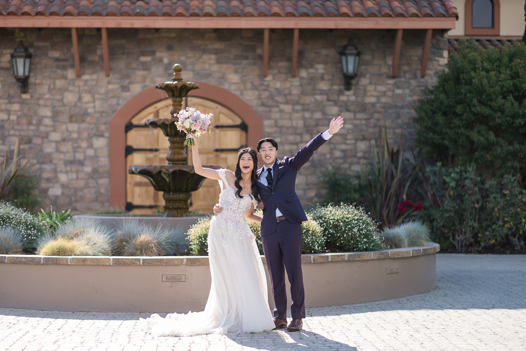 Newlyweds celebrating with arms raised