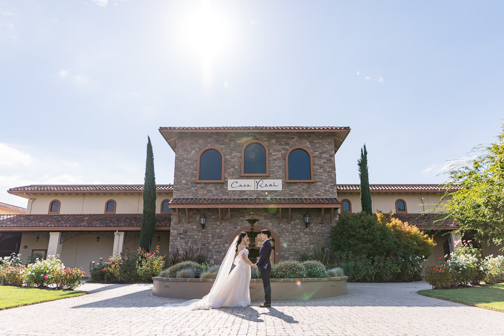 Bride and groom portrait in front of Casa Real wedding venue