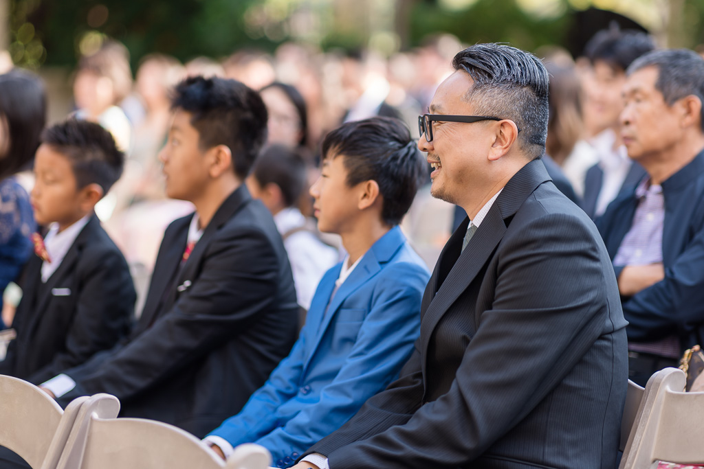 Wedding guests seated at outdoor ceremony