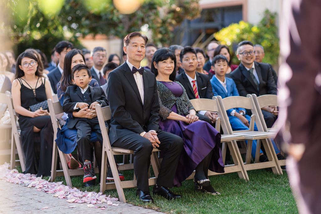 parents and wedding guests seated at outdoor ceremony