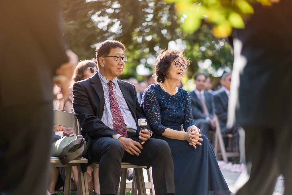 groom's parents watching outdoor wedding ceremony