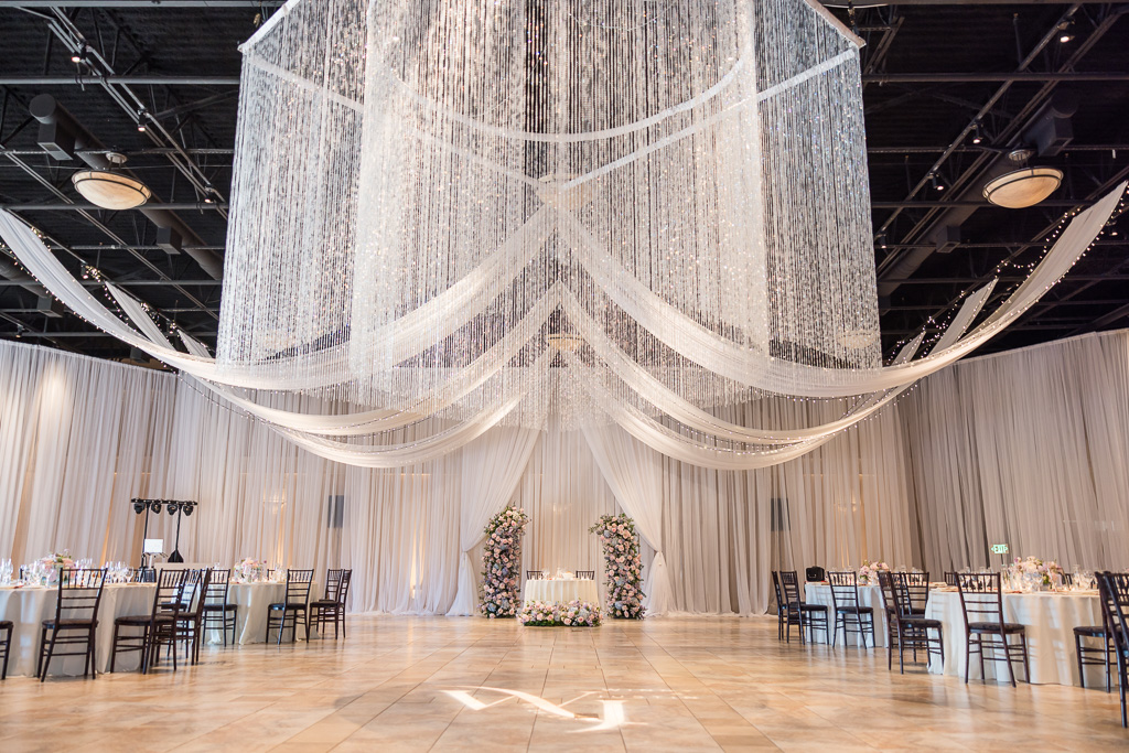 Casa Real reception ballroom with crystal chandelier and custom projection on the dance floor