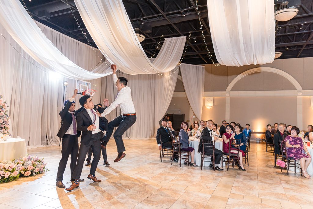 Groomsmen dunking a small basketball as they enter the wedding reception