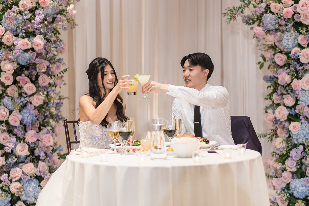 Bride and groom toasting at reception
