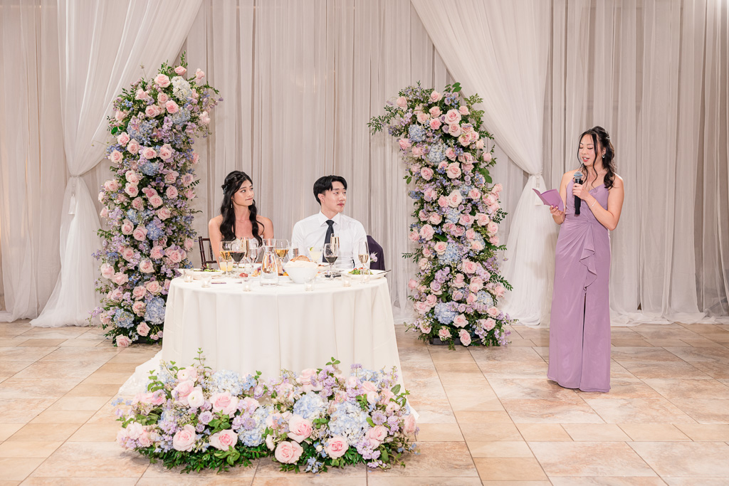 Bridesmaid giving speech at wedding reception