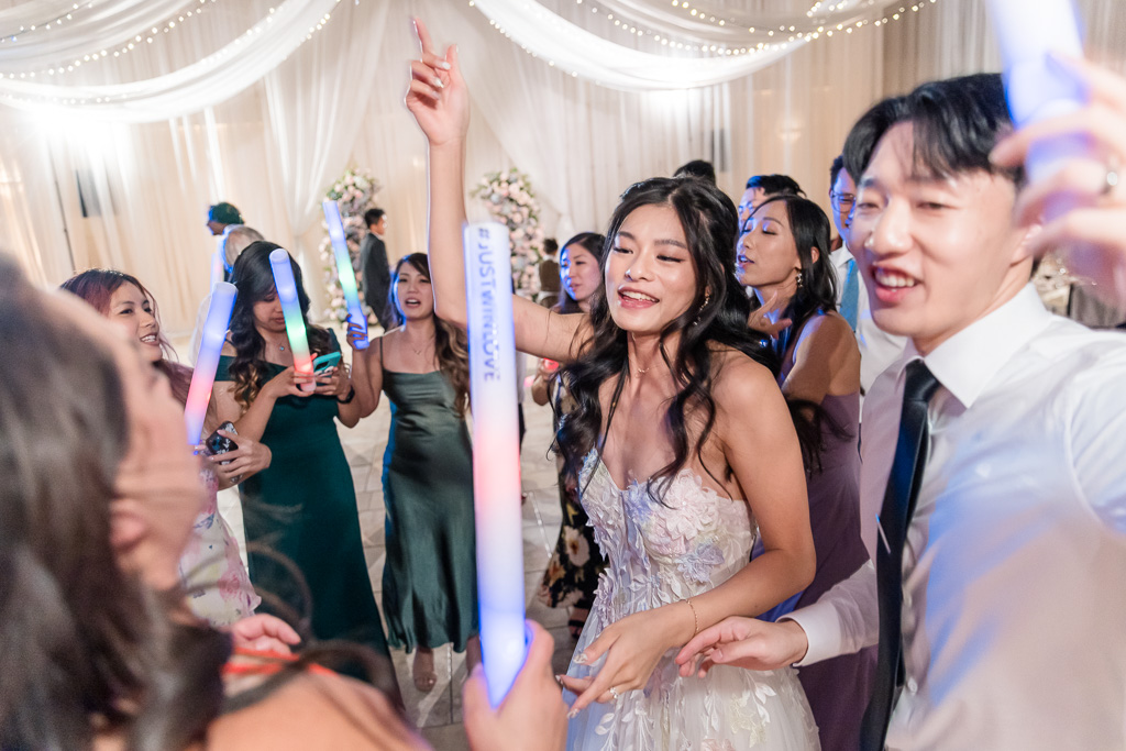 Bride and groom dancing with glow sticks at Pleasanton wedding reception