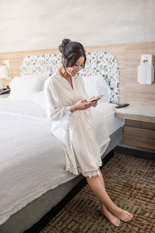 bride quickly texting a friend on the morning of her wedding day
