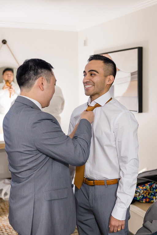 a couple of groomsmen getting ready