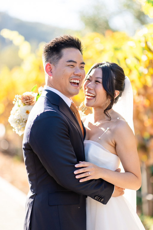 a happy candid moment between the bride and groom