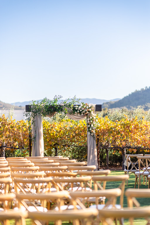 wooden chairs and arbor at MOHI Ranch wedding ceremony