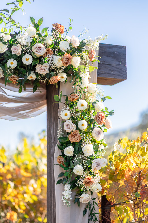 floral decor on wooden wedding arbor