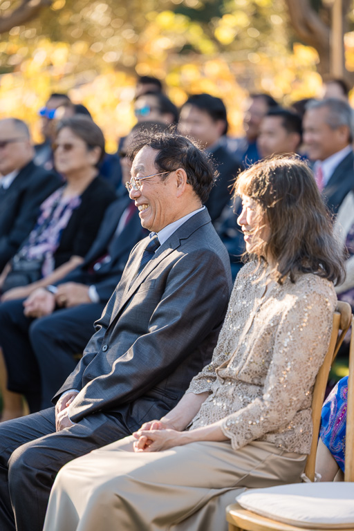 parents of the bride seated at the ceremony enjoying the wedding