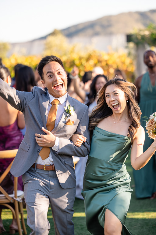 bridesmaid and groomsman walking down the aisle